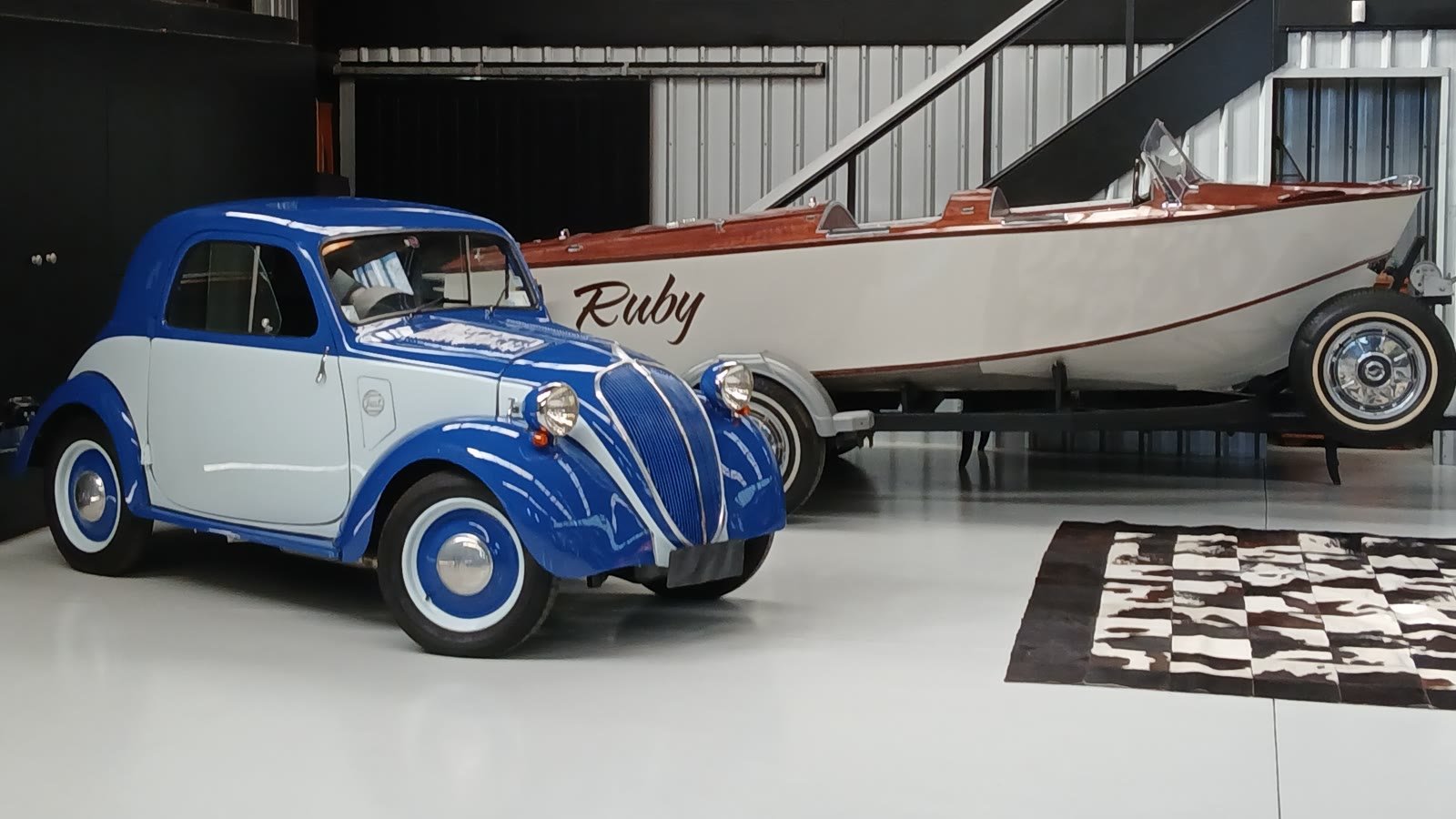The classic boat Ruby on her trailer with the Fiat 500 Topolino